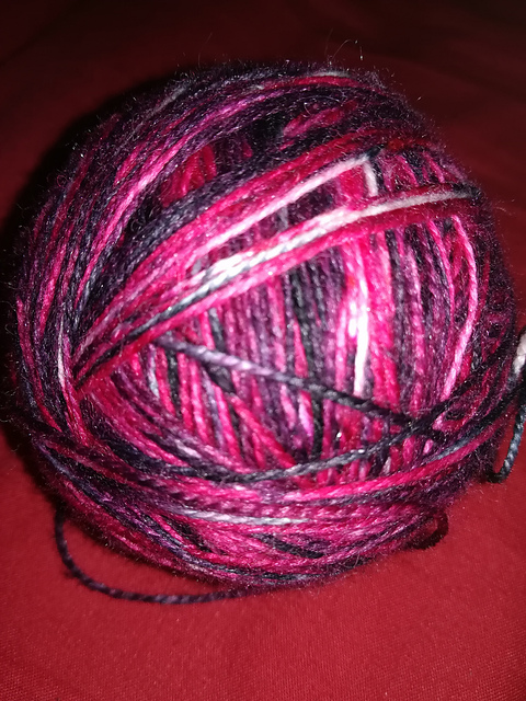 A ball of red and black variegated yarn
